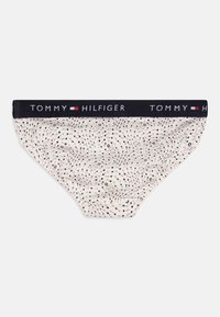 Slip da uomo Tommy Hilfiger in crema, con un elastico nero in vita con logo e un motivo di pois e vortici multicolori.
