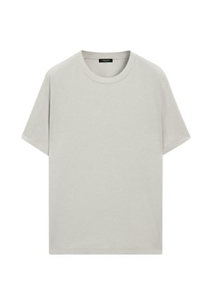 T-shirt beige clair uni à manches courtes et col rond, avec une étiquette noire à l'intérieur du col, présenté sur un fond blanc.