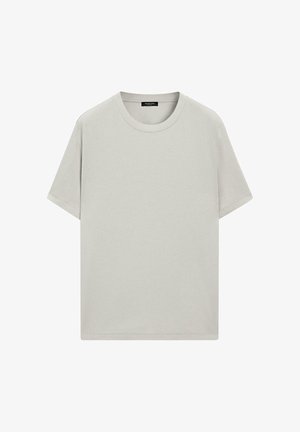 Schlichtes hellbeiges T-Shirt mit kurzen Ärmeln und Rundhalsausschnitt, mit einem schwarzen Etikett im Krageninneren, dargestellt vor weißem Hintergrund.