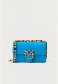 Bright blue leather shoulder bag with gold chain strap and a gold clasp featuring two birds facing each other on the front flap.
