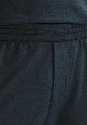 Ciemnoszare spodnie dresowe z elastycznym pasem i sznurkiem. Gładka tekstura z bocznymi kieszeniami i subtelnym melanżowym wzorem.