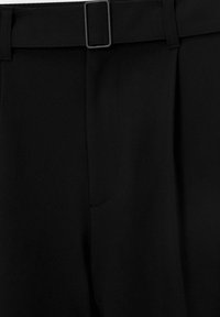 Black trousers with a smooth texture, featuring a flat front and pleats. Includes a wide belt with a rectangular buckle detail.