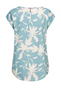 Haut bleu clair avec motifs floraux blancs, encolure ronde, manches courtes et une fermeture éclair visible dans le dos. Tissu doux et texturé.