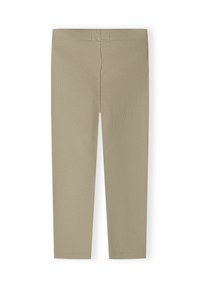 Beige geribbelde brei-legging met een elastische tailleband, plat getoond op een witte achtergrond.