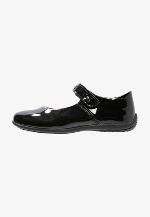 Black patent leather Mary Jane shoe with a rounded toe, adjustable strap, and flower-shaped embellishment on the strap. Flat sole.