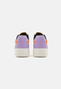 Lateral view of sneakers with purple leather, black accents, neon orange and blue details, and a white rubber sole. Smooth texture.