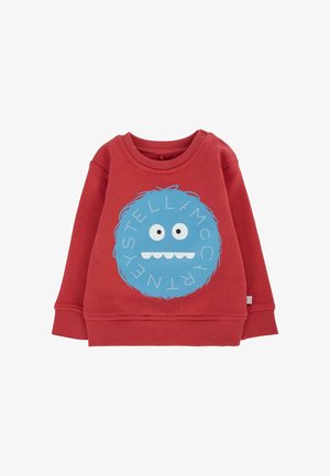 Czerwona bawełniana bluza z okrągłym graficznym wizerunkiem niebieskiego potwora z dużymi oczami i uśmiechniętą buzią, ozdobiona białymi literami wokół wzoru.