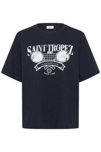 Tamsiai mėlynos per didelės marškinėlių su minkšta medžiaga, kuriuose yra balta grafika su kryžiuojančiomis teniso raketėmis ir tekstu "Saint Tropez".