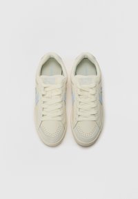 Cream-colored sneakers with a smooth leather upper, light blue accents, round toe, perforated detailing, and flat laces.