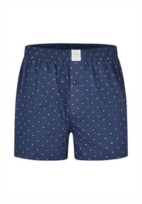 Mörkblå boxershorts i bomull med ett återkommande mönster av små beigefärgade prickar, försedd med elastisk midjerem och en framknapp.