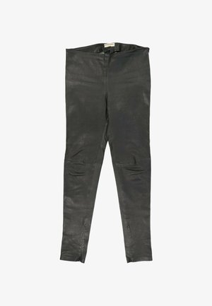 Sorte læderleggings med synlige syninger, lynlåse ved anklerne og et Balenciaga-mærke på det indvendige taljebånd.