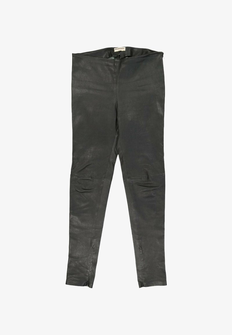 Leggings en cuir noir avec coutures visibles, fermetures éclair aux chevilles et une étiquette Balenciaga sur la ceinture intérieure.