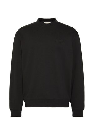 Felpa nera a maniche lunghe con scollo tondo, polsini e orlo a coste, con una piccola patch rettangolare nera con logo sul petto sinistro.