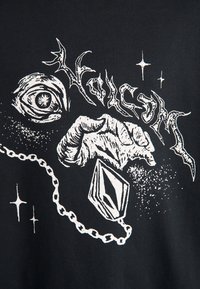 Tessuto nero con grafiche bianche che raffigurano un occhio, una mano che tiene un pendente e testo stilizzato, con dettagli di stelle e catene.