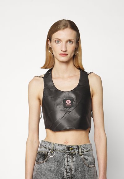 Black cropped top made of textured material, featuring a round neckline, chain accents on shoulders, and a pink brand tag on the front.