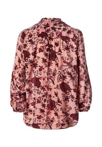 Blouse rose à manches longues avec épaules froncées et motif floral dans des tons rouge foncé et vert.