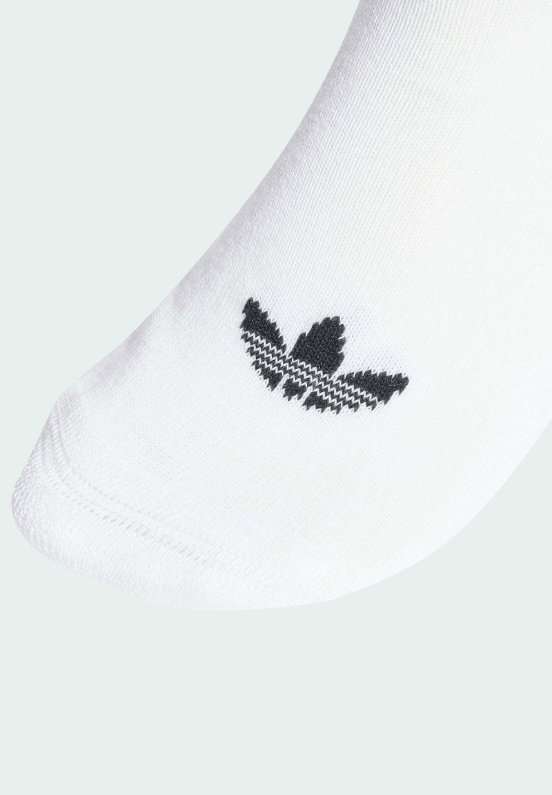 Calcetín blanco hasta el tobillo con un logo negro texturizado que recuerda a una hoja. Presenta una tela suave y un borde cosido para un ajuste ceñido.