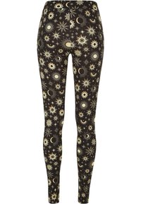 Leggings realizzati in tessuto elasticizzato con uno sfondo nero e motivi celesti dorati, tra cui stelle, soli e lune.