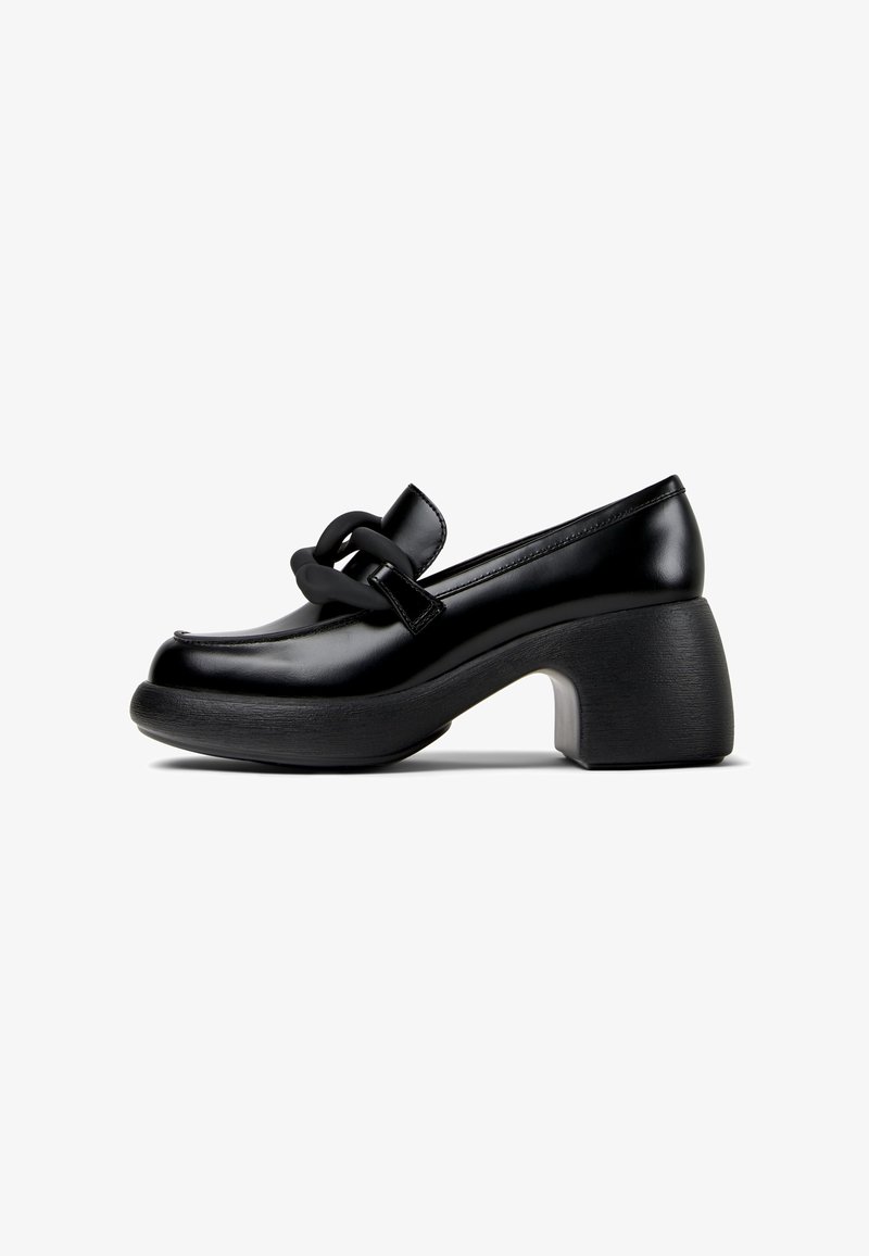 Mocassin noir à talon épais avec un bout arrondi et un grand détail chaîne noir mat sur la tige.