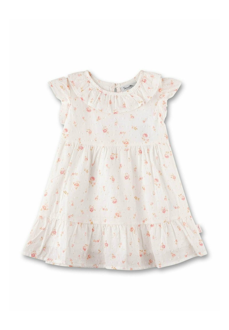 Blumenkleid mit kurzen Rüschensäulen, rundem Ausschnitt, leichtem Stoff und gestuften Rock. Überwiegend weiß mit rosa Blumen.