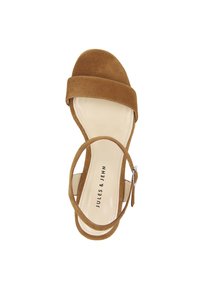 Brown suede sandal with a wide strap over the toe and a narrow ankle strap. The insole features black branding on a beige background.