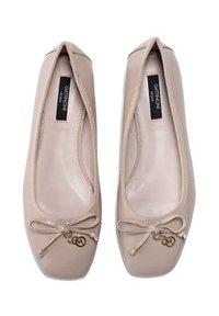 Beige leather ballet flats with rounded toe, thin elastic trim, and decorative bow with gold hardware. Smooth texture and simple design.