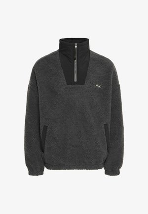 Ciemnoszary polarowy sweter z kołnierzem zapinanym na pół zamek, czarnymi akcentami na dekolcie i kieszeniach oraz teksturowaną tkaniną zapewniającą ciepło i komfort.