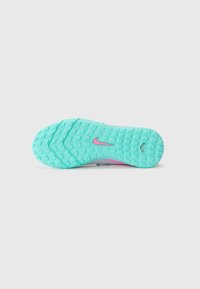 Nike sneaker sole featuring a turquoise rubber bottom with textured grip patterns and a pink accent logo.