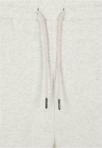 Light gray sweatpants fabric with a textured finish. Features contrasting drawstrings with metal tips. The waistband has elastic detailing.