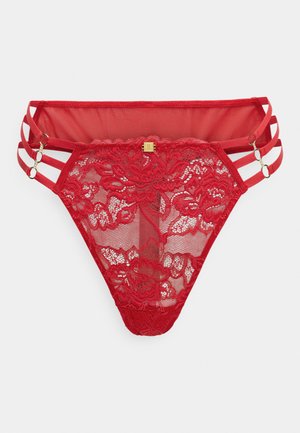 Punainen pitsinen tanga, jossa on läpikuultavat verkkomateriaalit. Kolmoishihnanyksiköt sivuilla ja kultasävyiset yksityiskohdat. Kukkakuvio koko vaatteessa.