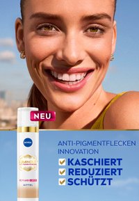 NIVEA Luminous CC Fluid in a white bottle with gold accents. Features anti-pigment properties. Background shows a smiling individual in a yellow top.