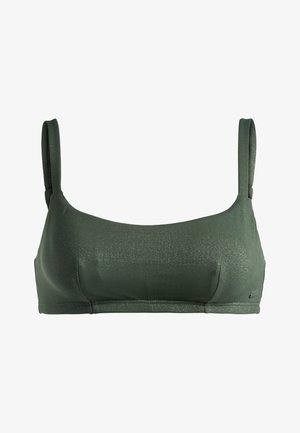 Vihreä kiiltävä bralette, jossa on ohuet hihnat, sileä pinta ja minimalistinen muotoilu. Sisältää pienen kiillon ja yksinkertaista ompelua.