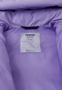 Lila Innenseite einer Jacke mit einem Pflegeetikett, das die Marke "reima" zeigt, Größe 128/8Y, und Anweisungen, sie weiterzugeben.