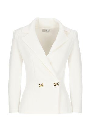 Blazer bianco a coste con colletto a punta e decorativi fiocchi dorati sulla parte frontale. Presenta maniche lunghe e una silhouette aderente.