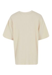 Tricou oversized de culoare crem, cu textură ribbed, mâneci scurte și decolteu rotund. Design minimalist, fără accente sau modele vizibile.
