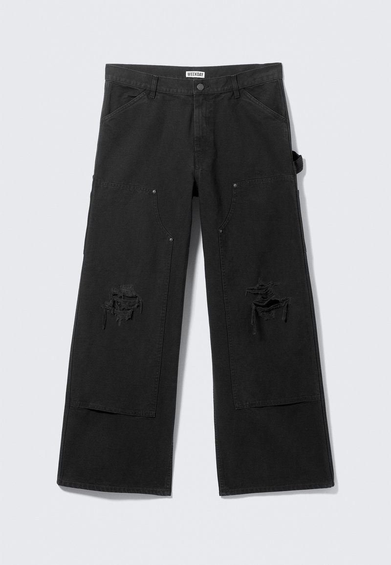 Pantalon cargo noir à jambes larges avec une taille haute, doté de grandes poches avant et de zones usées. Fabriqué en coton durable.