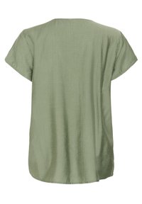 T-shirt ample à manches courtes de couleur vert clair, fabriqué dans un tissu lisse et légèrement texturé, avec un col rond et un ourlet arrondi.