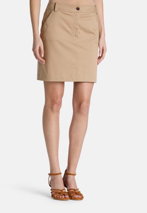 Khaki cotton skirt with a straight cut, front pockets, and a single button closure. Features a smooth texture and casual design.