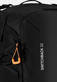 Black backpack featuring a textured design, orange toggle, and white "SWITCHBACK 32" branding. Designed for durability and functionality.