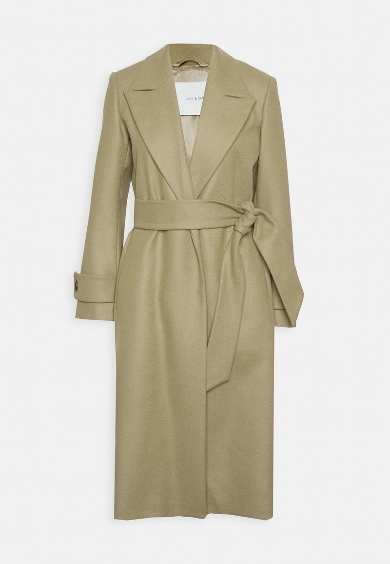 Beige overslagjas van gestructureerde stof, met een ceintuur in de taille, brede revers en met knopen sluitbare manchetten. Glad gevoerde binnenkant.