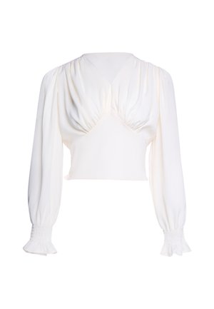 Weiße, kurz geschnittene Bluse mit langen Ärmeln, geraffter Vorderseite, aufgepufften Schultern und gesammelten elastischen Bündchen mit leichtem Rüschensaum.