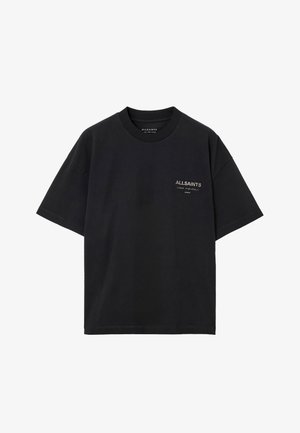 T-shirt en coton noir avec un col rond, des manches courtes et un petit logo blanc sur la poitrine gauche. Design simple et épuré.