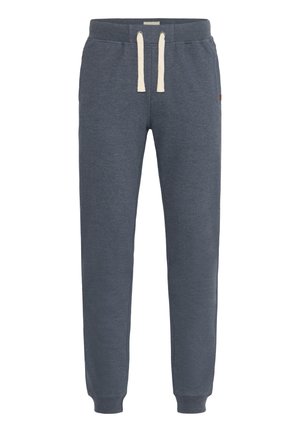 Dark blue sweatpants made from soft material, featuring a drawstring with cream-colored accents and ribbed cuffs at the ankles.