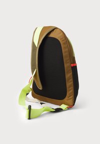 Brown and black backpack with a textured mesh back, featuring neon green accents and adjustable straps, designed for ergonomic carry.