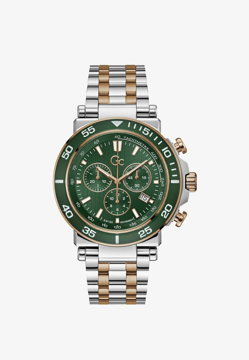 Kronograafkellaga rohelise taustaga, hõbedast ja kullast roostevabast terasest rihmaga ning kolme aladialiga. Omab julgeid valgeid tunni markereid ja takomeetri äärt.