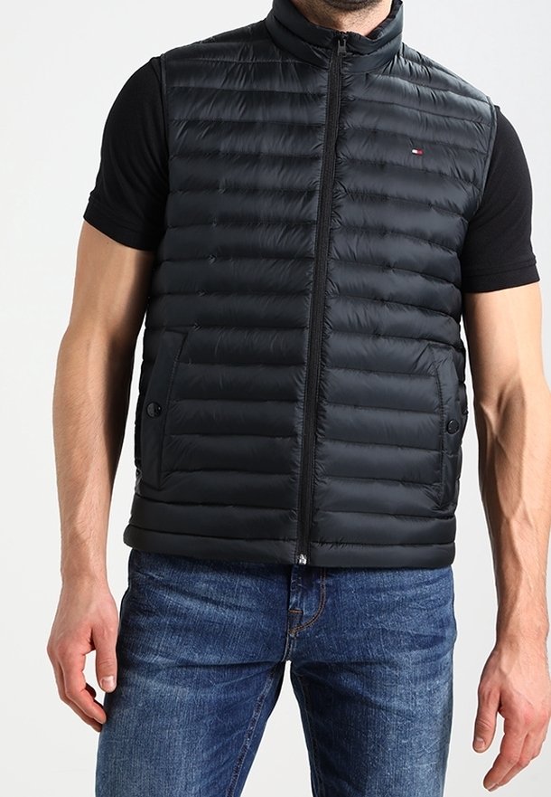 Black padded vest with a high collar, featuring a front zipper and two side pockets. Made of lightweight material with a smooth texture.