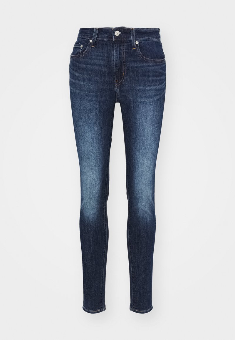Dunkelblaue Skinny-Jeans mit mittelhohem Bund, mit einem verblassten Muster, fünf Taschen sowie metallischem Knopf- und Reißverschluss.