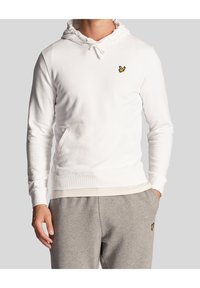 Hoodie bianco con coulisse, tasca frontale e logo di un uccello giallo sul petto. Tessuto morbido, polsini a coste e vestibilità rilassata.
