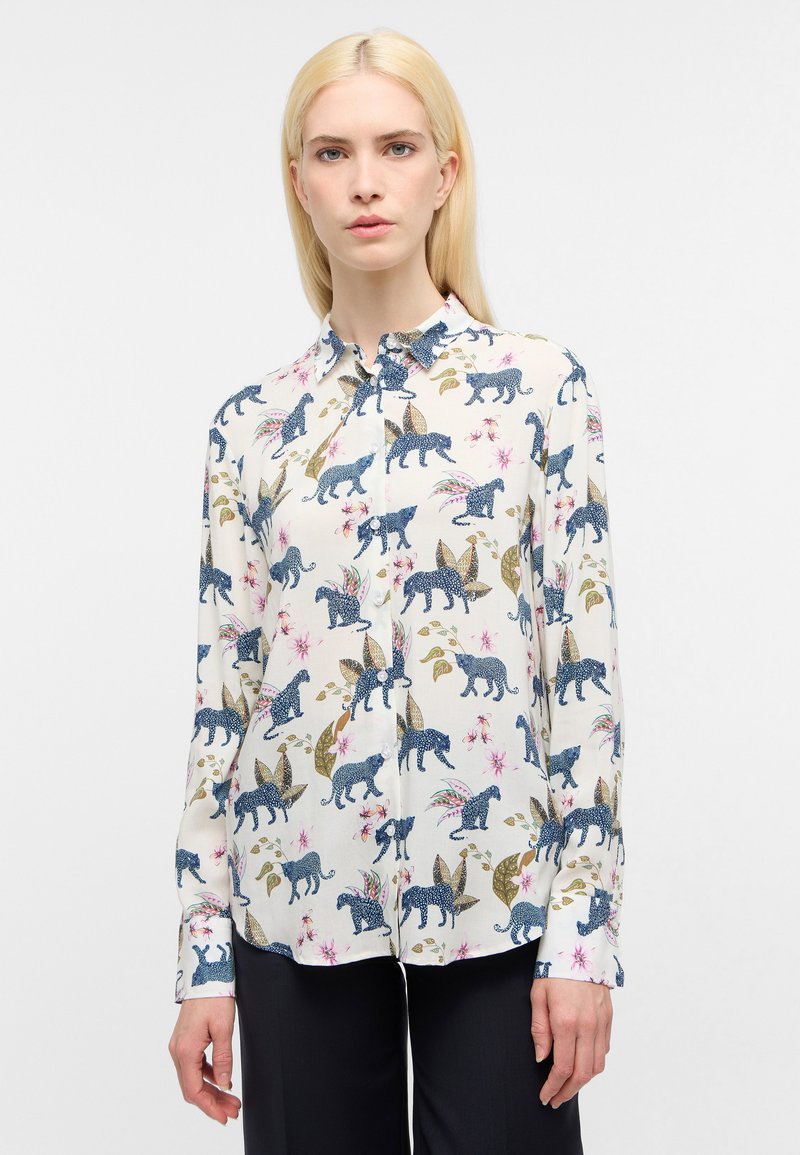 Overhemd met knoopsluiting in crèmekleurige stof met een kleurrijke dieren- en bloemenprint. Lange mouwen met knoopmanchetten en een klassieke kraag.