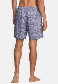 Swim shorts in navy blue with a white rose pattern, elastic waistband, and back pocket, showcasing a lightweight, smooth fabric texture.
